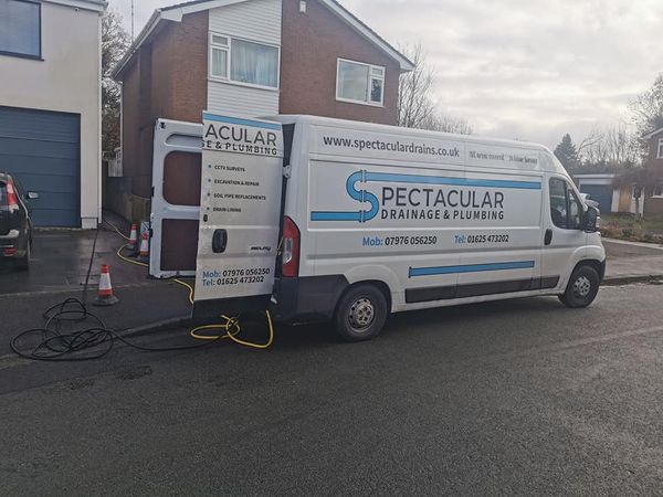 a white van with a yellow hose attached to the back